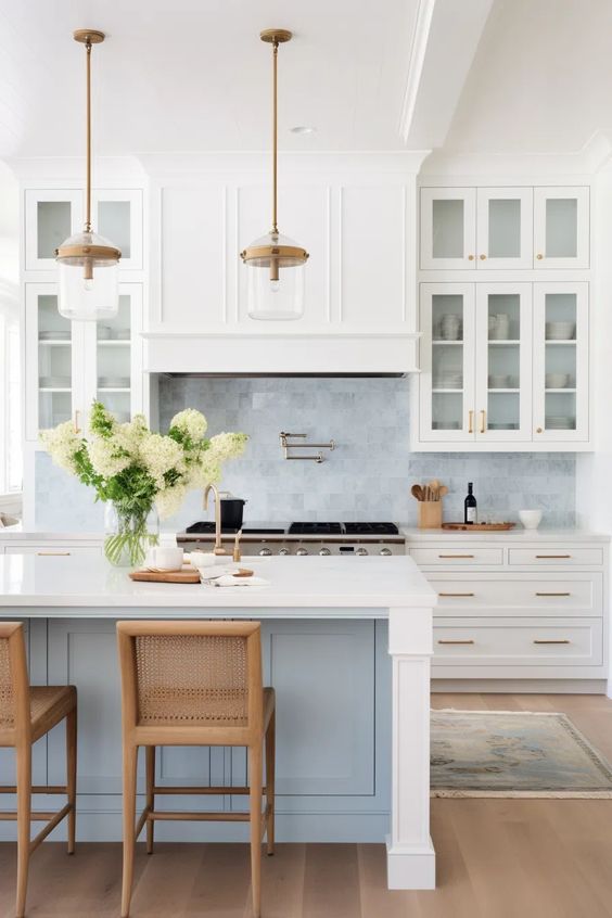 Baby blue and white kitchen with gold accents and glass cabinet doors