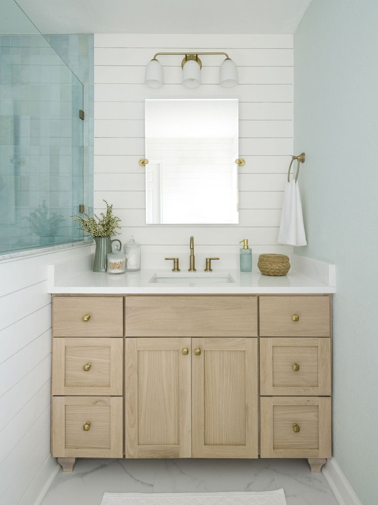 baby blue cloe tile bedrosians shower with delta champange bronze shower fixtures cape charles virginina bay creek bathroom renovation design white oak vanity with shiplap walls white snow sherwin williams kingston blue custom vanity honey bronze top knobs hardware