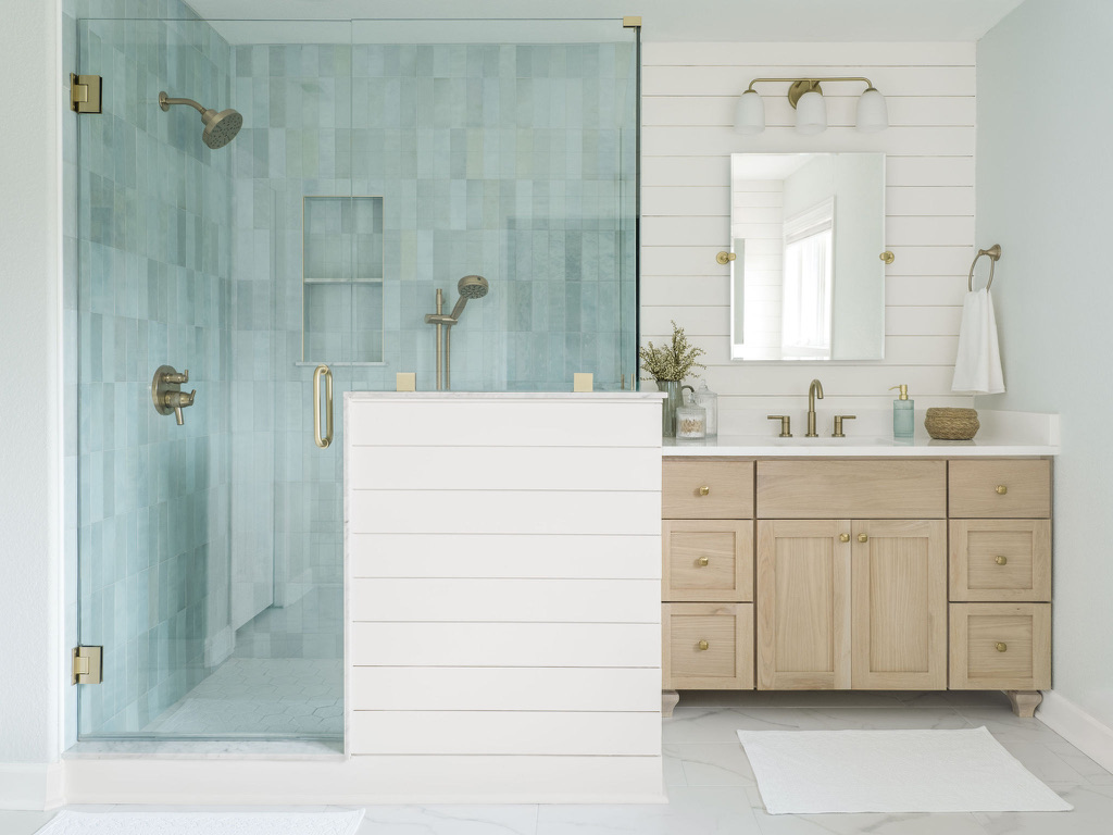 baby blue cloe tile bedrosians shower with delta champange bronze shower fixtures cape charles virginina bay creek bathroom renovation design white oak vanity with shiplap walls white snow sherwin williams kingston blue custom vanity honey bronze top knobs hardware
