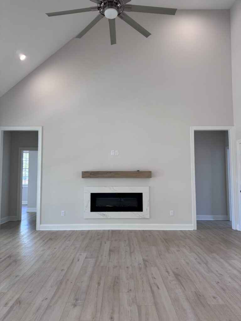 Before photo of builder-grade fireplace wall in Bay Creek home